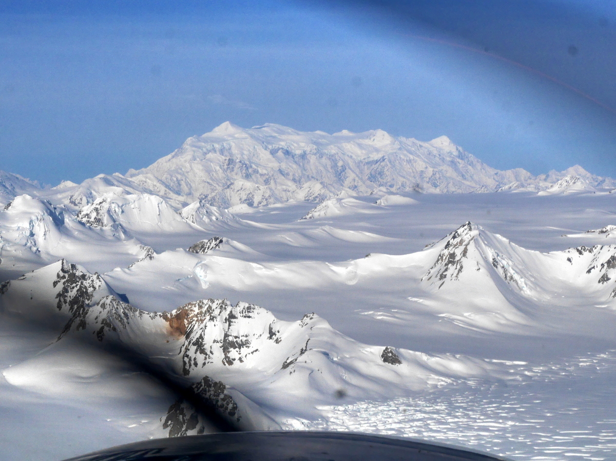 First view of Mt Logan. Not a very good photo as it was taken through the aircraft propeller. The scale of the mountain is difficult to grasp. The summit plateau is 2 miles above the surrounding glaciers and over 10 miles long.