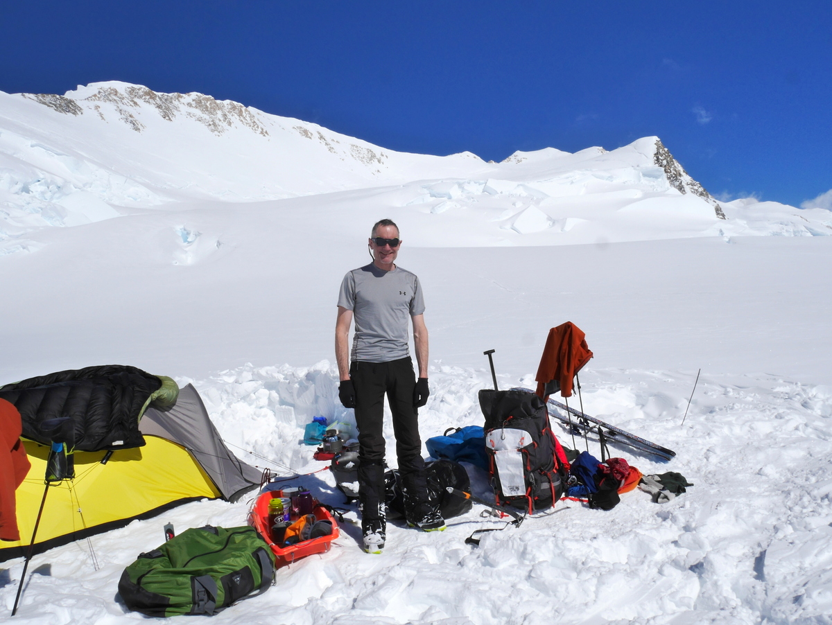 May 20: T-shirt weather on a rest day at the Football Field. The small notch in the skyline behind me is Prospector Col (18,100'), the gateway to the summit plateau. The main summit is just visible at the extreme right.